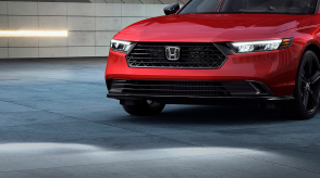 3/4 closeup of the front of a red Accord. 