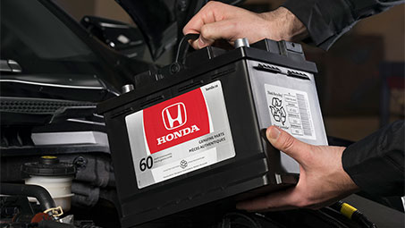 Studio shot of a genuine Acura car battery. // Une photo en studio d'une batterie de voiture Acura d’origine . 	